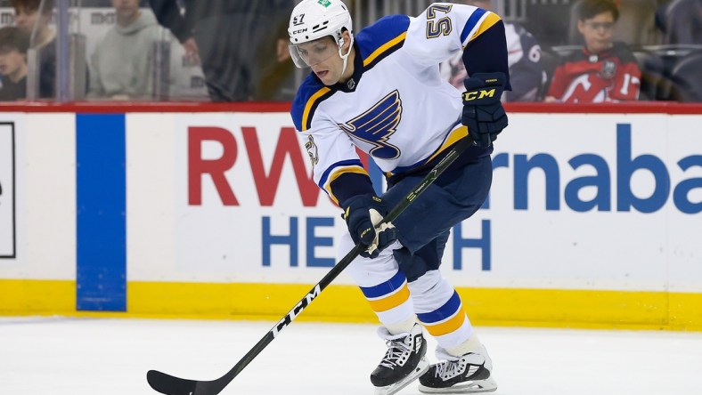 Mar 6, 2022; Newark, New Jersey, USA; St. Louis Blues left wing David Perron (57) controls the puck against New Jersey Devils during the first period at Prudential Center. Mandatory Credit: Tom Horak-USA TODAY Sports