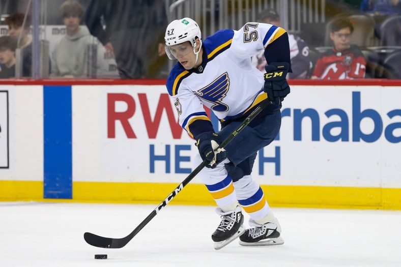Mar 6, 2022; Newark, New Jersey, USA; St. Louis Blues left wing David Perron (57) controls the puck against New Jersey Devils during the first period at Prudential Center. Mandatory Credit: Tom Horak-USA TODAY Sports