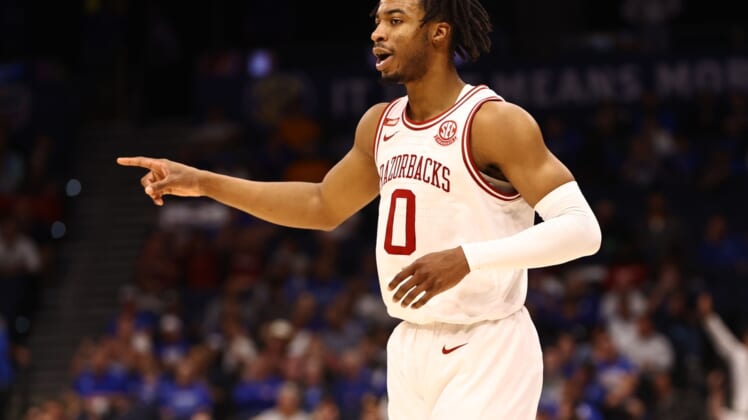 Mar 12, 2022; Tampa, FL, USA; Arkansas Razorbacks guard Stanley Umude (0) makes a three pointer against the Texas A&M Aggies during the first half at Amalie Arena. Mandatory Credit: Kim Klement-USA TODAY Sports