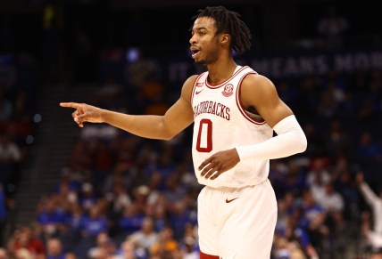 Mar 12, 2022; Tampa, FL, USA; Arkansas Razorbacks guard Stanley Umude (0) makes a three pointer against the Texas A&M Aggies during the first half at Amalie Arena. Mandatory Credit: Kim Klement-USA TODAY Sports