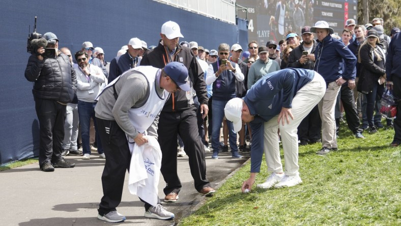 Mar 12, 2022; Ponte Vedra Beach, Florida, USA; Daniel Berger sets his ball after getting relief on the 18th hole during the first round of THE PLAYERS Championship golf tournament. Mandatory Credit: David Yeazell-USA TODAY Sports