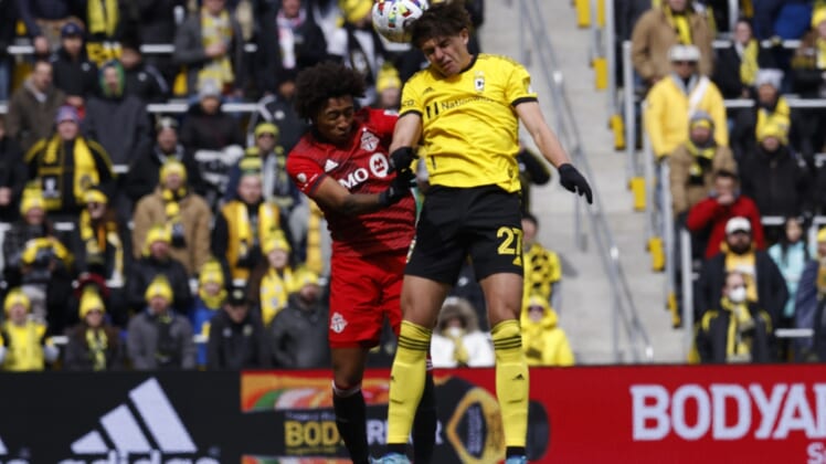 Mar 12, 2022; Columbus, Ohio, USA; Columbus Crew forward Miguel Berry (27) heads the ball against Toronto FC midfielder Jahkeele Marshall-Rutty (7) during the first half at Lower.com Field. Mandatory Credit: Greg Bartram-USA TODAY Sports