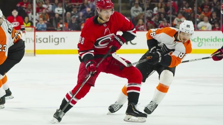 Mar 12, 2022; Raleigh, North Carolina, USA;  Carolina Hurricanes center Martin Necas (88) skates with the puck past Philadelphia Flyers left wing Joel Farabee (86) during the first period at PNC Arena. Mandatory Credit: James Guillory-USA TODAY Sports