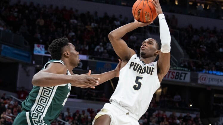 Mar 12, 2022; Indianapolis, IN, USA;  Purdue Boilermakers guard Brandon Newman (5) shoots the ball while Michigan State Spartans center Mady Sissoko (22) defends in the first half at Gainbridge Fieldhouse. Mandatory Credit: Trevor Ruszkowski-USA TODAY Sports