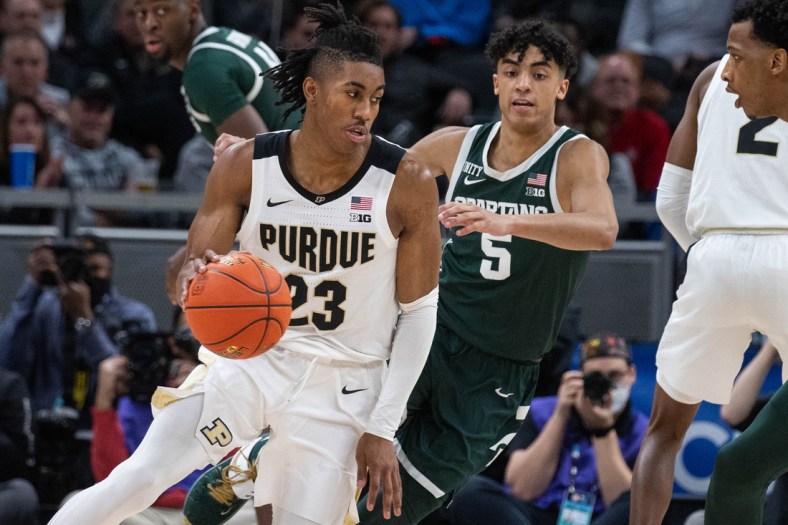 Mar 12, 2022; Indianapolis, IN, USA;  Purdue Boilermakers guard Jaden Ivey (23) dribbles the ball while Michigan State Spartans guard Max Christie (5) defends  in the second half at Gainbridge Fieldhouse. Mandatory Credit: Trevor Ruszkowski-USA TODAY Sports
