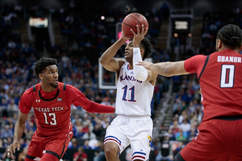 Mar 12, 2022; Kansas City, MO, USA;  Kansas Jayhawks guard Remy Martin (11) looks to pass during the first half against the Texas Tech Red Raidersat T-Mobile Center. Mandatory Credit: William Purnell-USA TODAY Sports