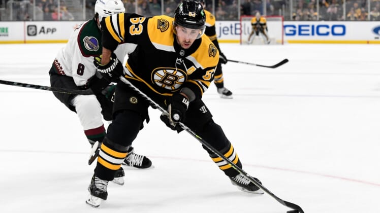Mar 12, 2022; Boston, Massachusetts, USA; Boston Bruins left wing Brad Marchand (63) controls the puck in front of Arizona Coyotes center Nick Schmaltz (8) during the first period at the TD Garden. Mandatory Credit: Brian Fluharty-USA TODAY Sports