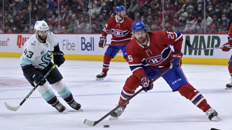 Mar 12, 2022; Montreal, Quebec, CAN; Montreal Canadiens defenseman Jeff Petry (26) takes a shot and Seattle Kraken forward Colin Blackwell (43) defends during the first period at the Bell Centre. Mandatory Credit: Eric Bolte-USA TODAY Sports