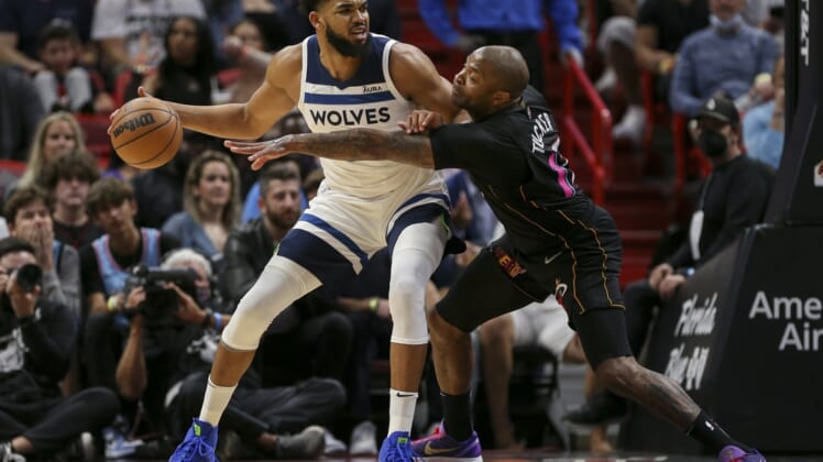 Mar 12, 2022; Miami, Florida, USA; Minnesota Timberwolves center Karl-Anthony Towns (32) protects the ball from Miami Heat forward P.J. Tucker (17) during the first quarter at FTX Arena. Mandatory Credit: Sam Navarro-USA TODAY Sports