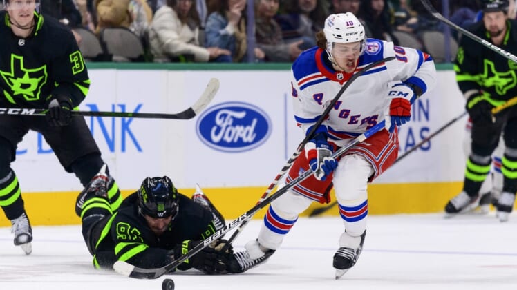 Mar 12, 2022; Dallas, Texas, USA; New York Rangers left wing Artemi Panarin (10) skates with the puck past Dallas Stars center Tyler Seguin (91) during the first period at the American Airlines Center. Mandatory Credit: Jerome Miron-USA TODAY Sports
