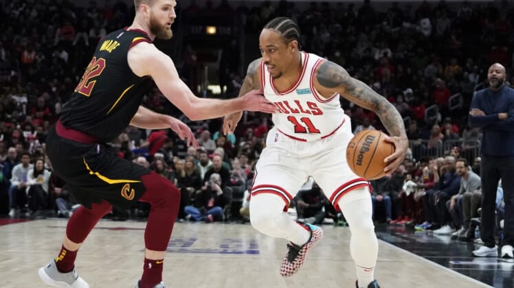 Mar 12, 2022; Chicago, Illinois, USA; Cleveland Cavaliers forward Dean Wade (32) defends Chicago Bulls forward DeMar DeRozan (11) during the first half at United Center. Mandatory Credit: David Banks-USA TODAY Sports