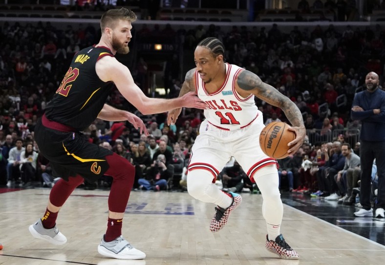 Mar 12, 2022; Chicago, Illinois, USA; Cleveland Cavaliers forward Dean Wade (32) defends Chicago Bulls forward DeMar DeRozan (11) during the first half at United Center. Mandatory Credit: David Banks-USA TODAY Sports