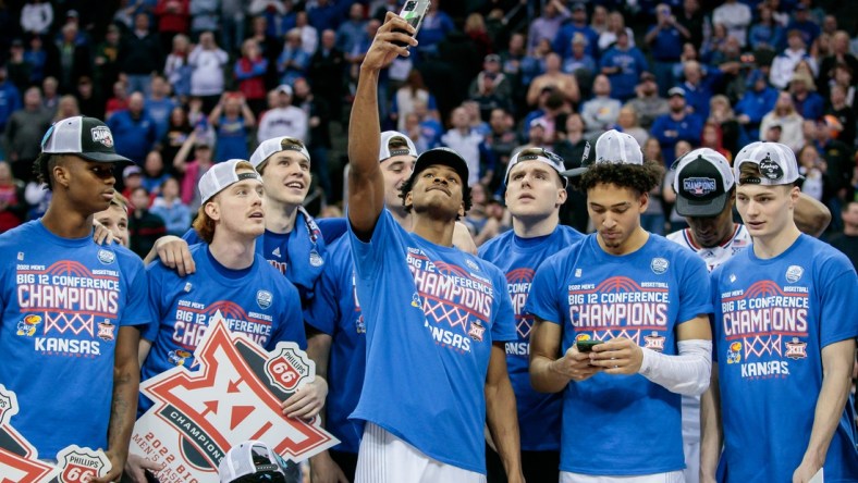 Mar 12, 2022; Kansas City, MO, USA; Kansas Jayhawks guard Ochai Agbaji (30) takes a selfie with the team after the game against the Texas Tech Red Raiders at T-Mobile Center. Mandatory Credit: William Purnell-USA TODAY Sports