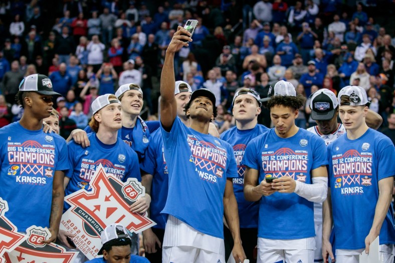 Mar 12, 2022; Kansas City, MO, USA; Kansas Jayhawks guard Ochai Agbaji (30) takes a selfie with the team after the game against the Texas Tech Red Raiders at T-Mobile Center. Mandatory Credit: William Purnell-USA TODAY Sports
