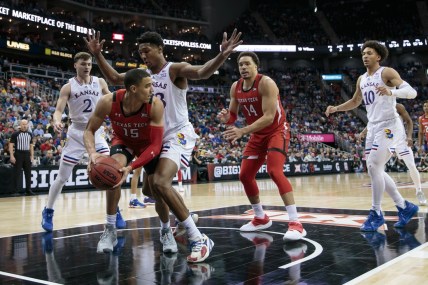 Mar 12, 2022; Kansas City, MO, USA; Kansas Jayhawks forward David McCormack (33) traps Texas Tech Red Raiders guard Kevin McCullar (15) under the basket during the second half at T-Mobile Center. Mandatory Credit: William Purnell-USA TODAY Sports