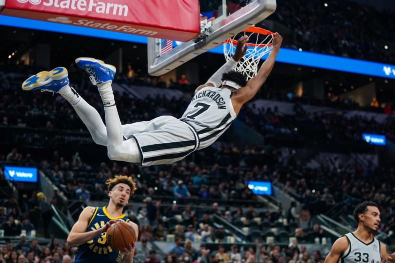 Mar 12, 2022; San Antonio, Texas, USA;  San Antonio Spurs guard Josh Richardson (7) hangs on the rim in the first half against the Indiana Pacers at the AT&T Center. Mandatory Credit: Daniel Dunn-USA TODAY Sports