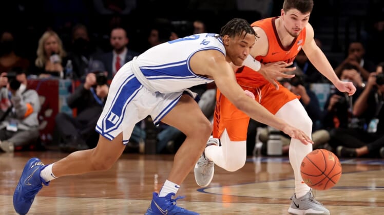 Mar 12, 2022; Brooklyn, NY, USA; Duke Blue Devils forward Wendell Moore Jr. (0) and Virginia Tech Hokies guard Hunter Cattoor (0) fight for a loose ball during the first half of the ACC Men's Basketball Tournament final at Barclays Center. Mandatory Credit: Brad Penner-USA TODAY Sports