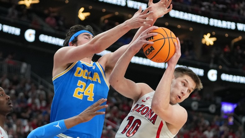 Mar 12, 2022; Las Vegas, NV, USA; Arizona Wildcats forward Azuolas Tubelis (10) pulls a rebound away from UCLA Bruins guard Jaime Jaquez Jr. (24) during the first half at T-Mobile Arena. Mandatory Credit: Stephen R. Sylvanie-USA TODAY Sports