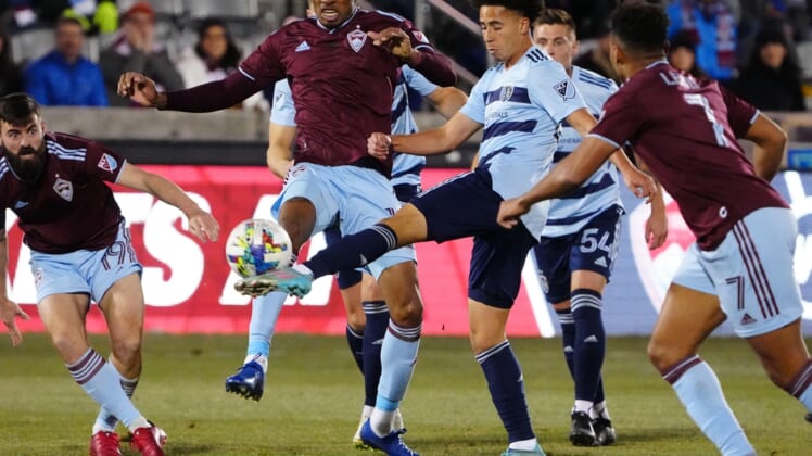 Mar 12, 2022; Commerce City, Colorado, USA; Sporting Kansas City midfielder Cameron Duke (28) and Colorado Rapids midfielder Mark-Anthony Kaye (14) reach for the ball in the first half at Dick's Sporting Goods Park. Mandatory Credit: Ron Chenoy-USA TODAY Sports