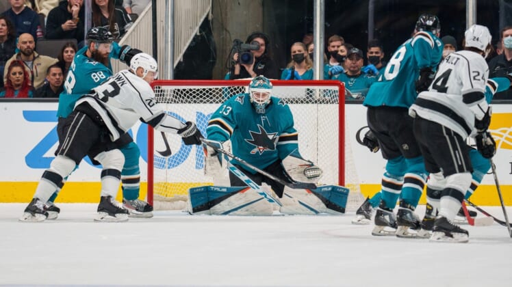 Mar 12, 2022; San Jose, California, USA;  San Jose Sharks goaltender Adin Hill (33) makes a save against Los Angeles Kings right wing Dustin Brown (23) during the first period at SAP Center at San Jose. Mandatory Credit: Neville E. Guard-USA TODAY Sports