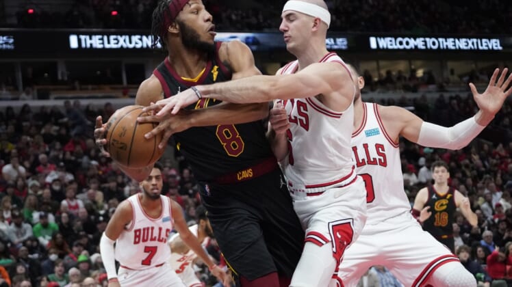 Mar 12, 2022; Chicago, Illinois, USA; Chicago Bulls guard Alex Caruso (6) defends Cleveland Cavaliers forward Lamar Stevens (8) during the second half at United Center. Mandatory Credit: David Banks-USA TODAY Sports