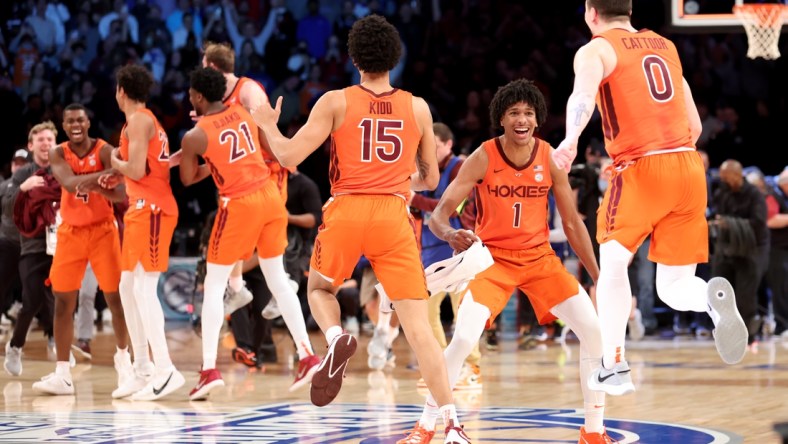 Mar 12, 2022; Brooklyn, NY, USA; Virginia Tech Hokies forward David N'Guessan (1) celebrates with center Lynn Kidd (15) and guard Hunter Cattoor (0) after defeating the Duke Blue Devils 82-67 in the ACC Men's Basketball Tournament final at Barclays Center. Mandatory Credit: Brad Penner-USA TODAY Sports