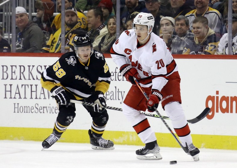 Mar 13, 2022; Pittsburgh, Pennsylvania, USA;  Carolina Hurricanes center Sebastian Aho (20) handles the puck against Pittsburgh Penguins left wing Jake Guentzel (59) during the second period at PPG Paints Arena. Mandatory Credit: Charles LeClaire-USA TODAY Sports