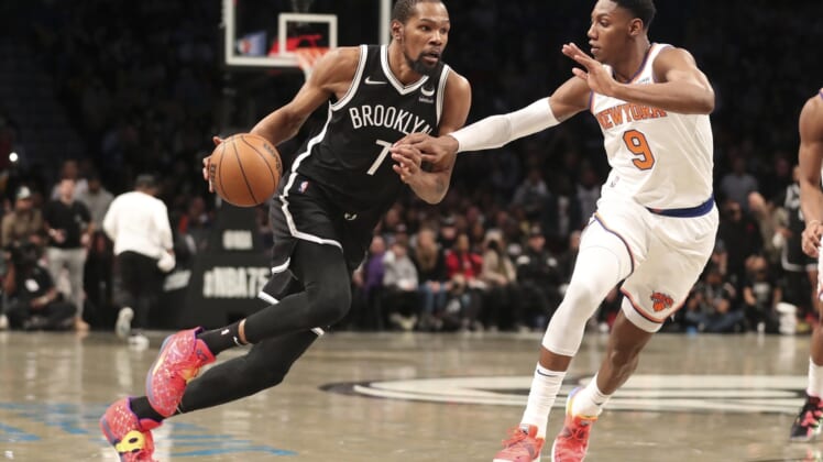Mar 13, 2022; Brooklyn, New York, USA;  Brooklyn Nets forward Kevin Durant (7) drives against New York Knicks guard RJ Barrett (9) in the fourth quarter at Barclays Center. Mandatory Credit: Wendell Cruz-USA TODAY Sports