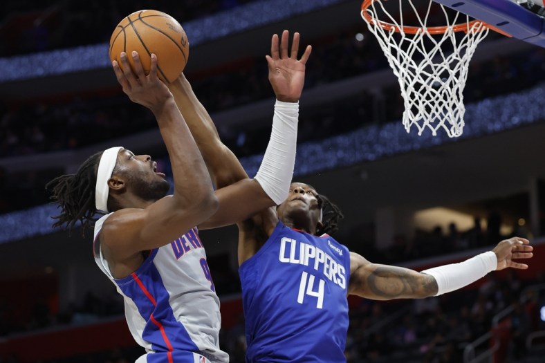 Mar 13, 2022; Detroit, Michigan, USA;  Detroit Pistons forward Jerami Grant (9) is fouled by LA Clippers guard Terance Mann (14) in the first half at Little Caesars Arena. Mandatory Credit: Rick Osentoski-USA TODAY Sports