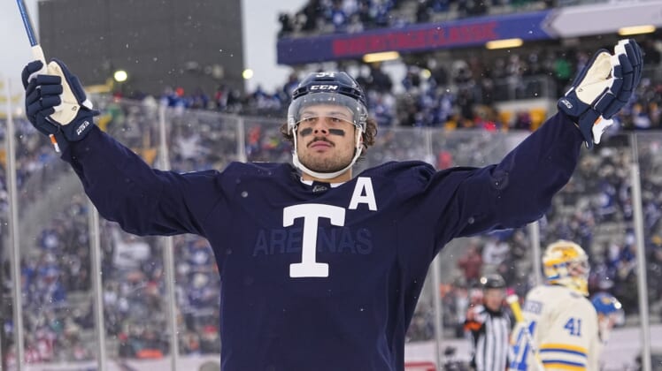 Mar 13, 2022; Hamilton, Ontario, CAN; Toronto Maple Leafs forward Auston Matthews (34) celebrats his goal against Buffalo Sabres goaltender Craig Anderson (41) during the second period in the 2022 Heritage Classic ice hockey game at Tim Hortons Field. Mandatory Credit: John E. Sokolowski-USA TODAY Sports