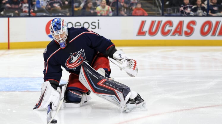 Mar 13, 2022; Columbus, Ohio, USA;  Columbus Blue Jackets goaltender Elvis Merzlikins (90) controls the puck against the Vegas Golden Knights in the first period at Nationwide Arena. Mandatory Credit: Aaron Doster-USA TODAY Sports