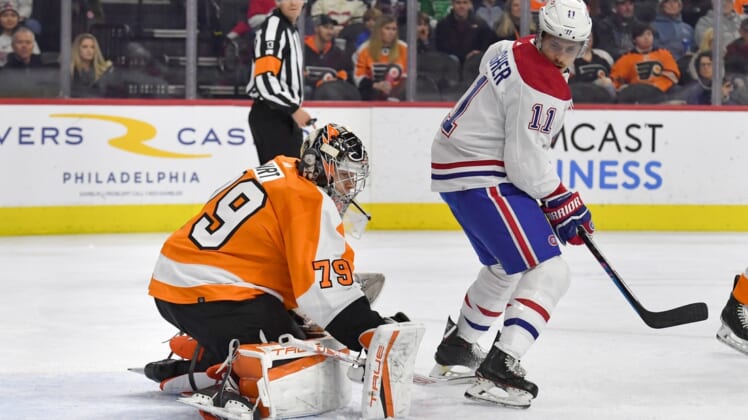 Mar 13, 2022; Philadelphia, Pennsylvania, USA; Philadelphia Flyers goaltender Carter Hart (79) makes a save as Montreal Canadiens right wing Brendan Gallagher (11) looks on during the first period at Wells Fargo Center. Mandatory Credit: Eric Hartline-USA TODAY Sports
