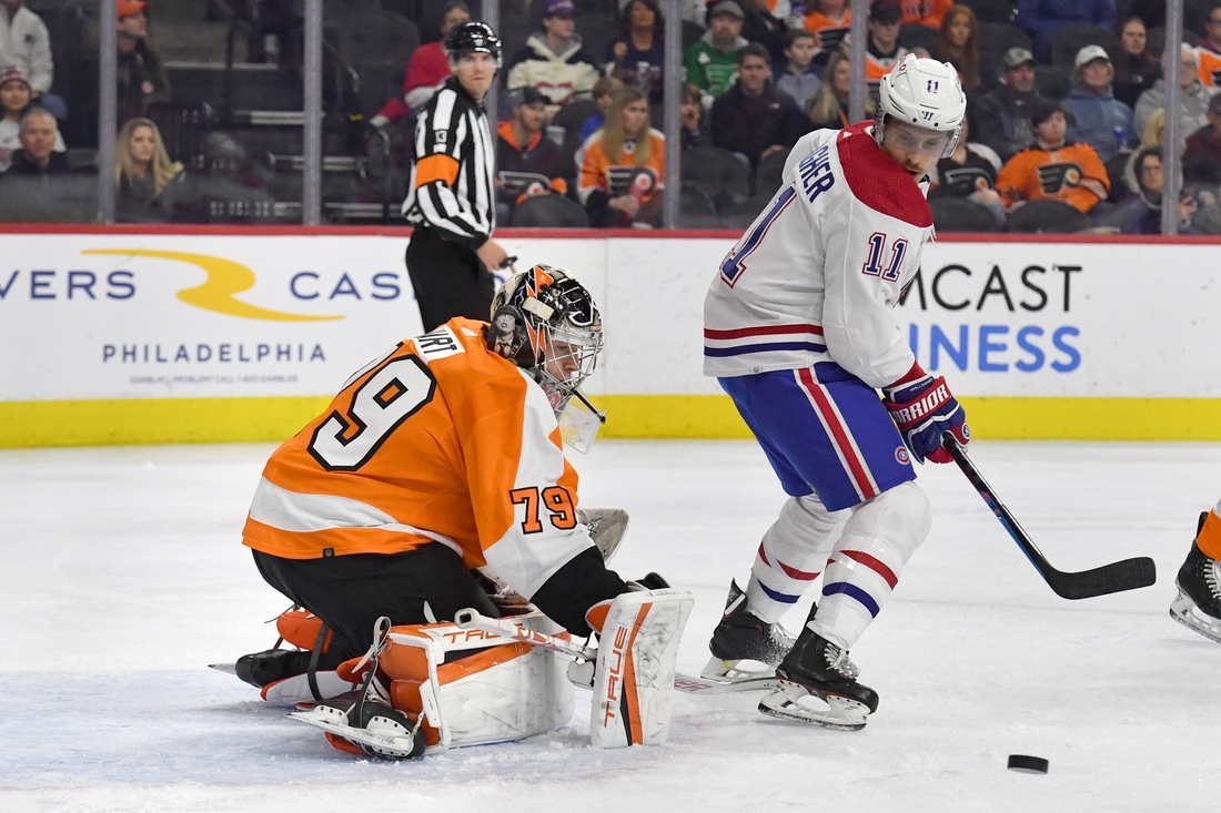 Mar 13, 2022; Philadelphia, Pennsylvania, USA; Philadelphia Flyers goaltender Carter Hart (79) makes a save as Montreal Canadiens right wing Brendan Gallagher (11) looks on during the first period at Wells Fargo Center. Mandatory Credit: Eric Hartline-USA TODAY Sports