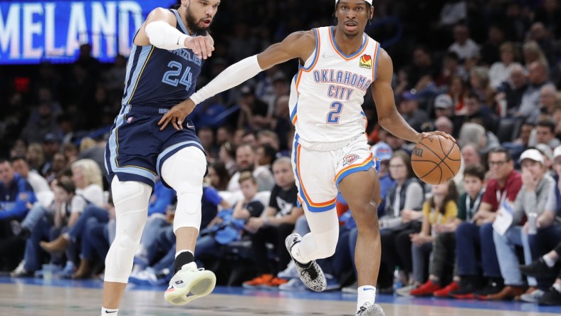 Mar 13, 2022; Oklahoma City, Oklahoma, USA; Oklahoma City Thunder guard Shai Gilgeous-Alexander (2) dribbles the ball down the court ahead of Memphis Grizzlies forward Dillon Brooks (24) during the second quarter at Paycom Center. Mandatory Credit: Alonzo Adams-USA TODAY Sports