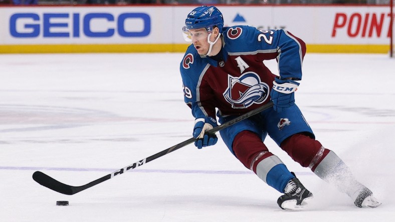 Mar 13, 2022; Denver, Colorado, USA; Colorado Avalanche center Nathan MacKinnon (29) controls the puck in the second period against the Calgary Flames at Ball Arena. Mandatory Credit: Isaiah J. Downing-USA TODAY Sports