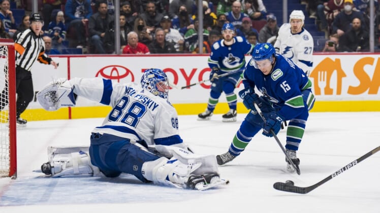 Mar 13, 2022; Vancouver, British Columbia, CAN; Tampa Bay Lightning goalie Andrei Vasilevskiy (88) makes a save on Vancouver Canucks forward Matthew Highmore (15) in the first period at Rogers Arena. Mandatory Credit: Bob Frid-USA TODAY Sports