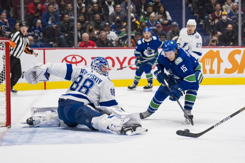 Mar 13, 2022; Vancouver, British Columbia, CAN; Tampa Bay Lightning goalie Andrei Vasilevskiy (88) makes a save on Vancouver Canucks forward Matthew Highmore (15) in the first period at Rogers Arena. Mandatory Credit: Bob Frid-USA TODAY Sports