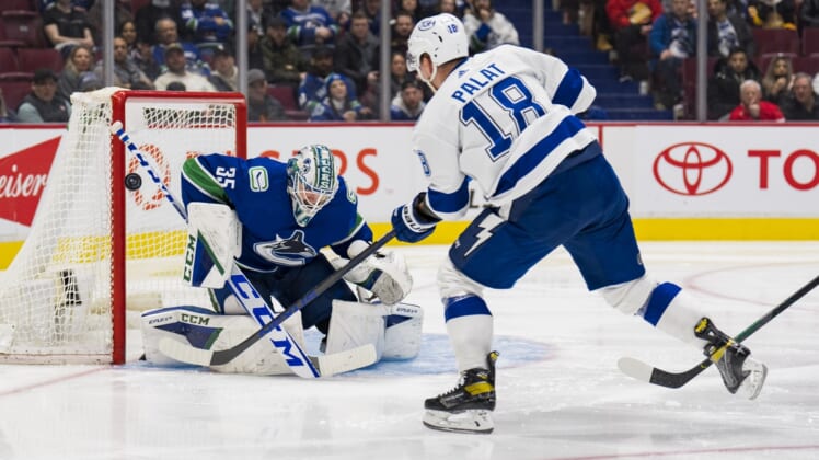 Mar 13, 2022; Vancouver, British Columbia, CAN; Vancouver Canucks goalie Thatcher Demko (35) makes a save on Tampa Bay Lightning forward Ondrej Palat (18) in the second period at Rogers Arena. Mandatory Credit: Bob Frid-USA TODAY Sports