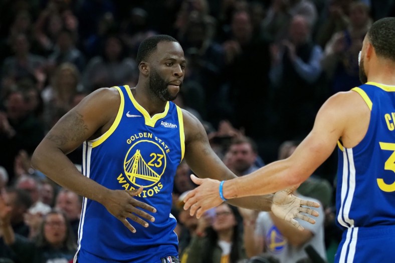 Mar 14, 2022; San Francisco, California, USA; Golden State Warriors forward Draymond Green (23) high fives guard Stephen Curry (30) as he enters the game during the first quarter against the Washington Wizards at Chase Center. Mandatory Credit: Kelley L Cox-USA TODAY Sports