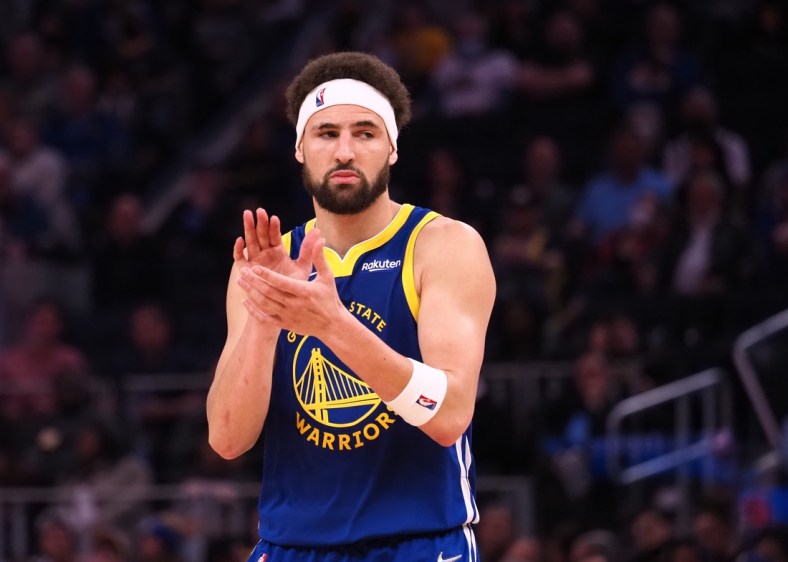 Mar 14, 2022; San Francisco, California, USA; Golden State Warriors guard Klay Thompson (11) claps as he reenters the game against the Washington Wizards during the fourth quarter at Chase Center. Mandatory Credit: Kelley L Cox-USA TODAY Sports