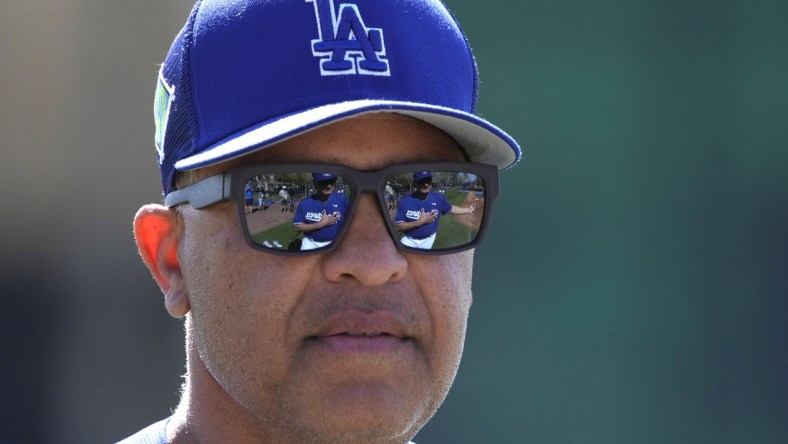 Mar 15, 2022; Glendale, AZ, USA; Los Angeles Dodgers manager Dave Roberts (30) watches warmups during spring training camp at Camelback Ranch. Mandatory Credit: Rick Scuteri-USA TODAY Sports