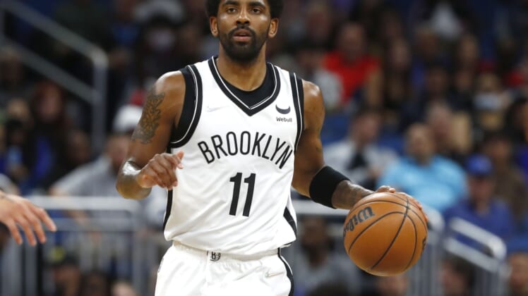 Mar 15, 2022; Orlando, Florida, USA; Brooklyn Nets guard Kyrie Irving (11) dribbles against the Orlando Magic during the first quarter at Amway Center. Mandatory Credit: Kim Klement-USA TODAY Sports
