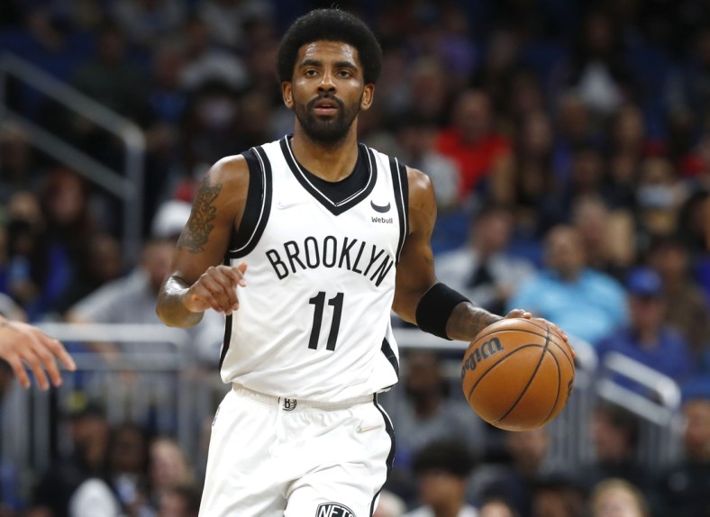 Mar 15, 2022; Orlando, Florida, USA; Brooklyn Nets guard Kyrie Irving (11) dribbles against the Orlando Magic during the first quarter at Amway Center. Mandatory Credit: Kim Klement-USA TODAY Sports