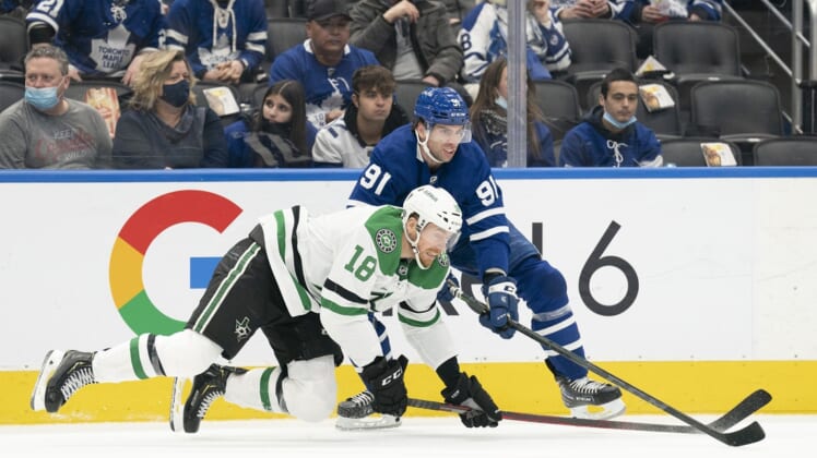 Mar 15, 2022; Toronto, Ontario, CAN; Toronto Maple Leafs center John Tavares (91) battles with Dallas Stars left wing Michael Raffl (18) during the second period at Scotiabank Arena. Mandatory Credit: Nick Turchiaro-USA TODAY Sports