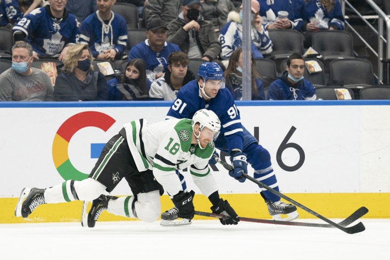 Mar 15, 2022; Toronto, Ontario, CAN; Toronto Maple Leafs center John Tavares (91) battles with Dallas Stars left wing Michael Raffl (18) during the second period at Scotiabank Arena. Mandatory Credit: Nick Turchiaro-USA TODAY Sports