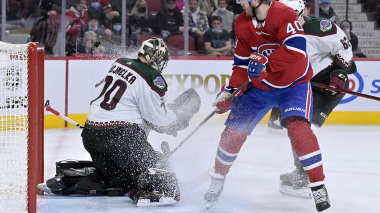Mar 15, 2022; Montreal, Quebec, CAN; Arizona Coyotes goalie Karel Vejmelka (70) makes a save against Montreal Canadiens forward Joel Armia (40) during the second period at the Bell Centre. Mandatory Credit: Eric Bolte-USA TODAY Sports