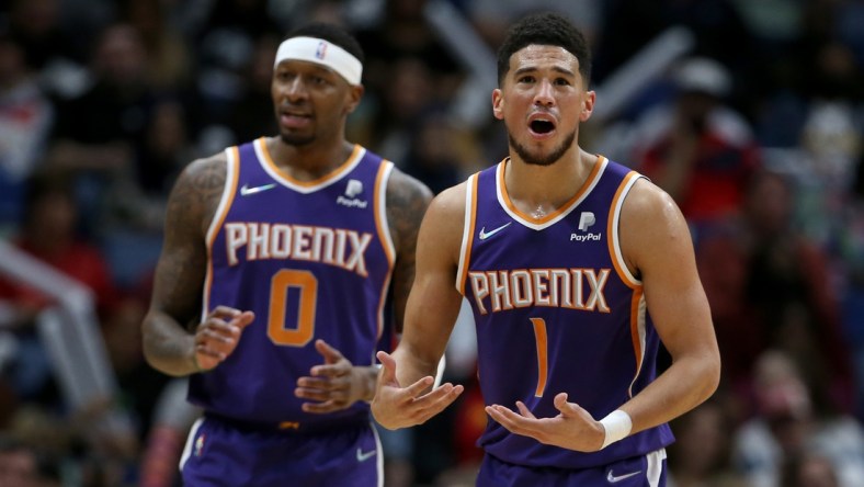 Mar 15, 2022; New Orleans, Louisiana, USA; Phoenix Suns guard Devin Booker (1) and forward Torrey Craig (0) gesture after a call in the first quarter against the New Orleans Pelicans at the Smoothie King Center. Mandatory Credit: Chuck Cook-USA TODAY Sports