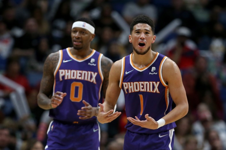 Mar 15, 2022; New Orleans, Louisiana, USA; Phoenix Suns guard Devin Booker (1) and forward Torrey Craig (0) gesture after a call in the first quarter against the New Orleans Pelicans at the Smoothie King Center. Mandatory Credit: Chuck Cook-USA TODAY Sports