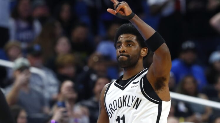 Mar 15, 2022; Orlando, Florida, USA; Brooklyn Nets guard Kyrie Irving (11) celebrates during the second half after scoring a career high 60 points against the Orlando Magic at Amway Center. Mandatory Credit: Kim Klement-USA TODAY Sports