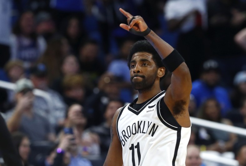 Mar 15, 2022; Orlando, Florida, USA; Brooklyn Nets guard Kyrie Irving (11) celebrates during the second half after scoring a career high 60 points against the Orlando Magic at Amway Center. Mandatory Credit: Kim Klement-USA TODAY Sports